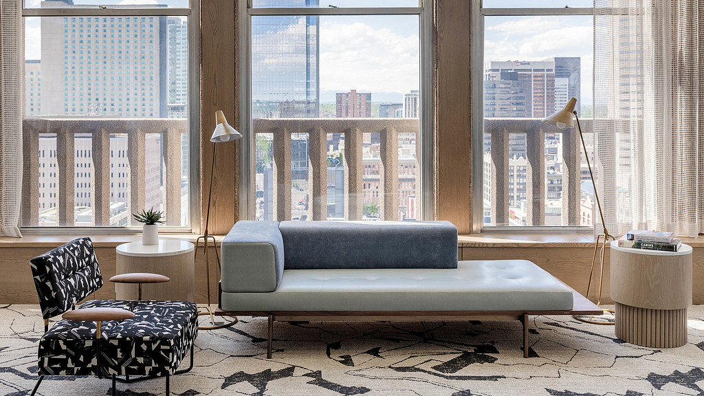 A couch and chairs in front of a window.